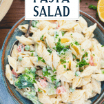 Close overhead image of cold pasta salad recipe with text title overlay at top