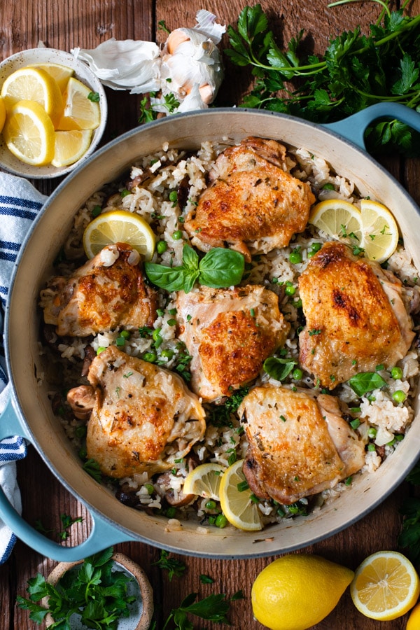 Overhead image of a Dutch oven full of one pot chicken thighs and rice recipe