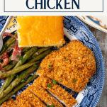 Close overhead shot of sliced baked pecan crusted chicken on a plate with text title overlay