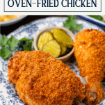 Close up side shot of oven fried chicken on a plate with text title box at top