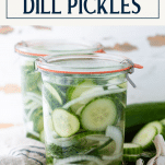 Side shot of jars of refrigerator dill pickles with a text title box at the top