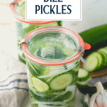 Jars of refrigerator dill pickles on a table with text title overlay