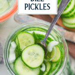 Close overhead shot of a fork in a jar of refrigerator dill pickles with text title overlay