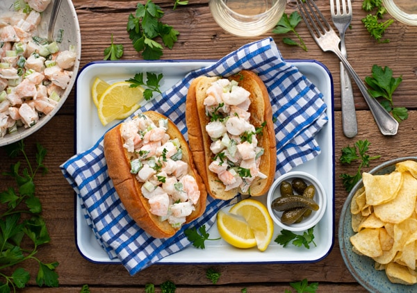 Horizontal overhead image of a tray of shrimp rolls on a picnic table