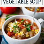 Close up side shot of a bowl of homemade vegetable soup with text title box at top