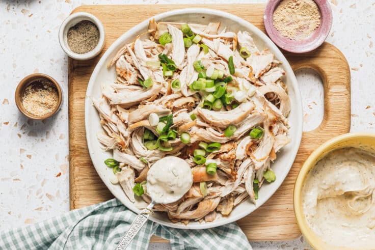 Adding the dressing to chicken salad.
