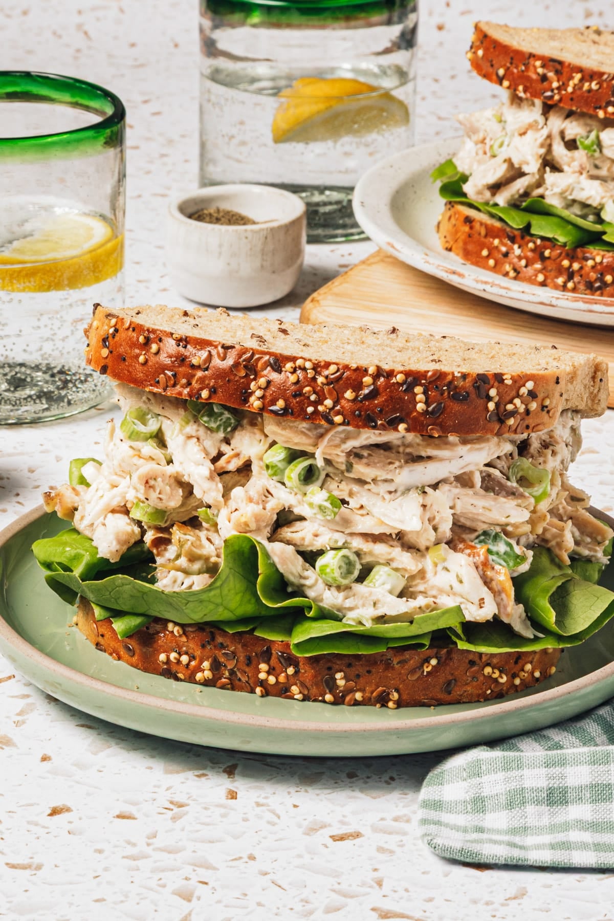 Side shot of the best chicken salad recipe served on whole wheat bread for a sandwich.