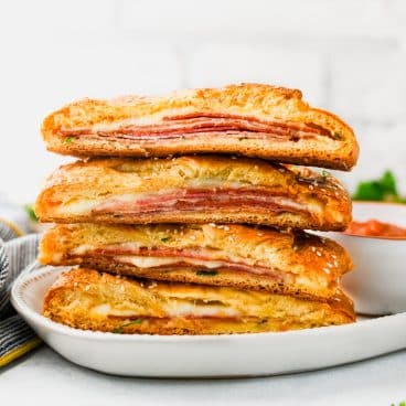 Square side shot of a stack of slices of crescent roll stromboli.