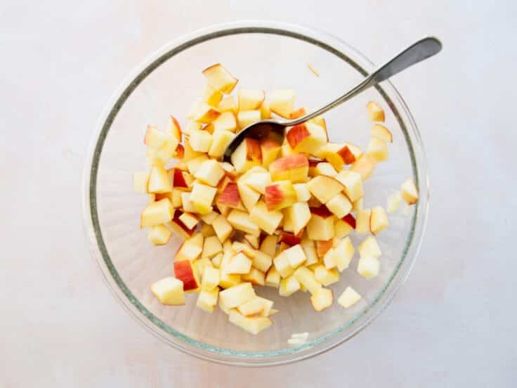 Stirring together the apples with lemon juice.