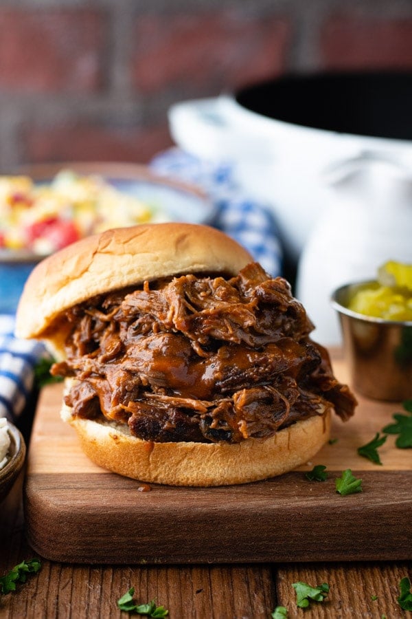 BBQ Beef on a bun with a side of pickles