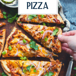 Child's hand picking up bbq chicken pizza with text title overlay