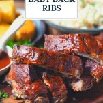 Platter of baked baby back ribs with text title overlay