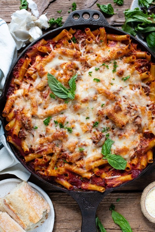 Pan of the best baked ziti recipe garnished with fresh basil