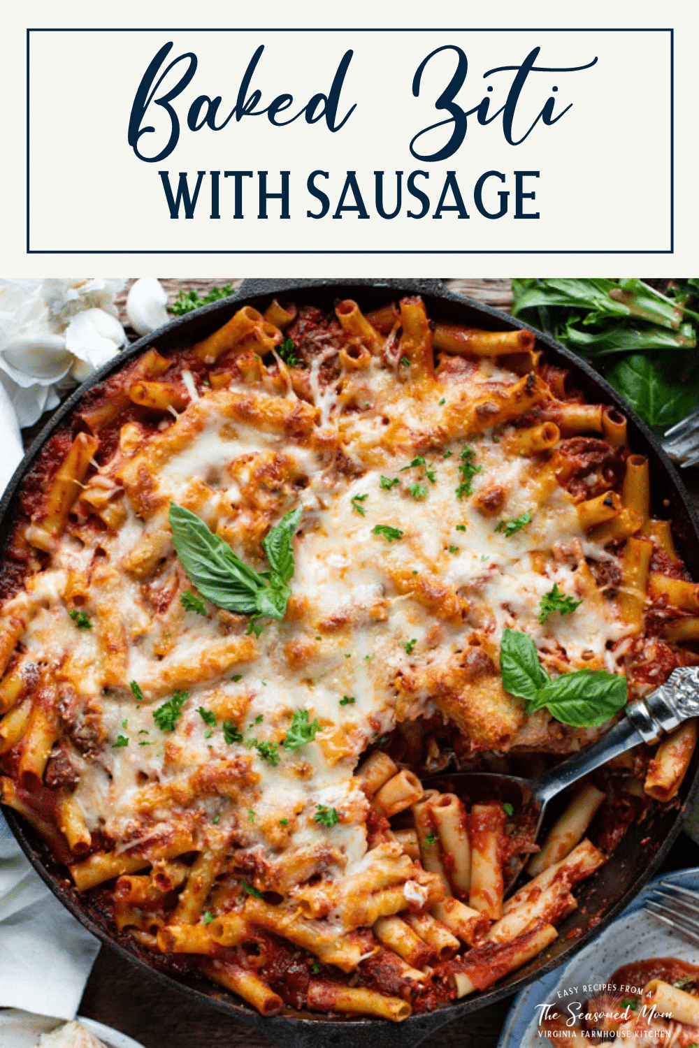 Overhead shot of a spoon in a dish of baked ziti with text title box at top