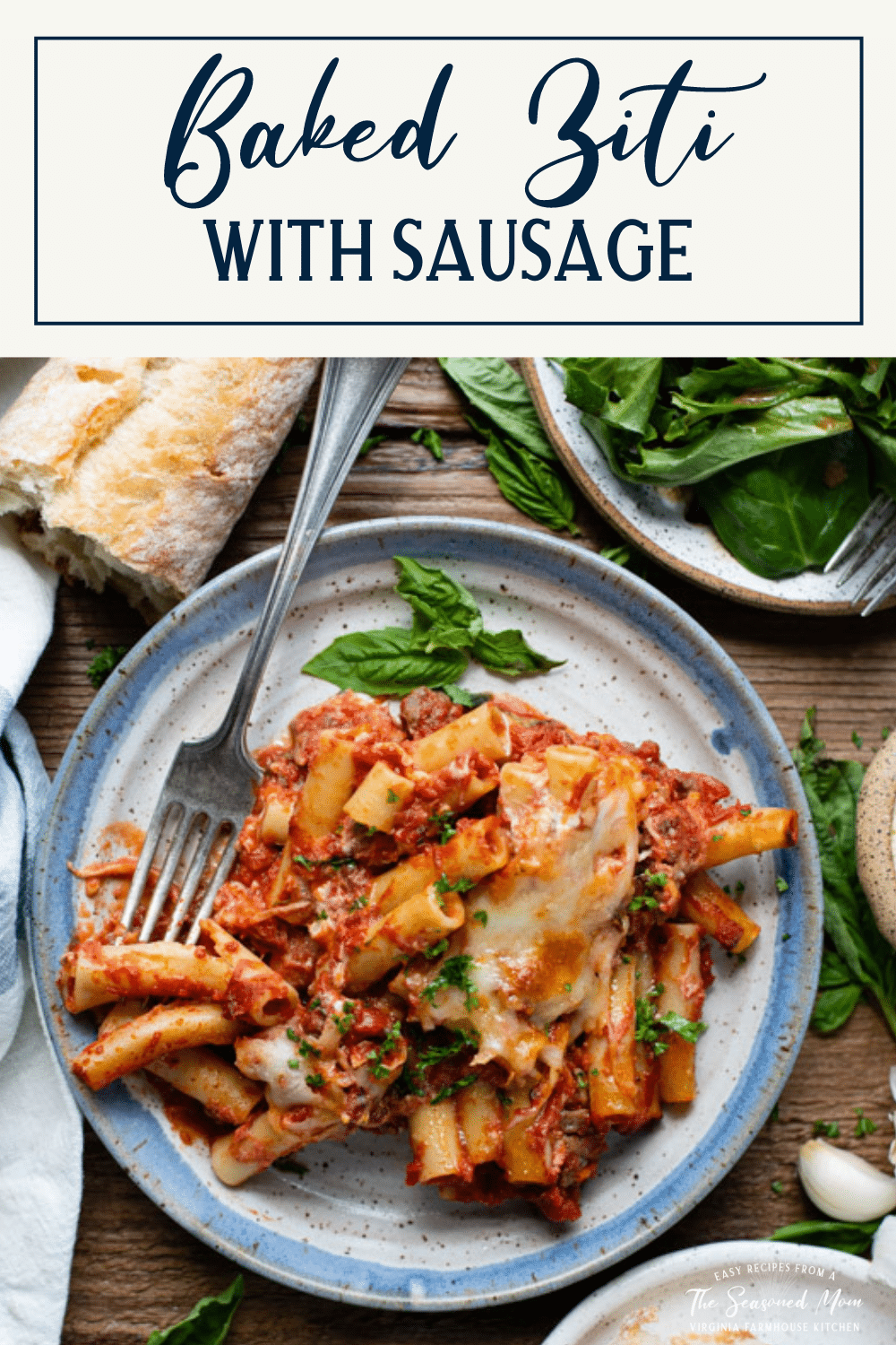 Overhead shot of a plate of baked ziti with sausage and ricotta and text title box at top