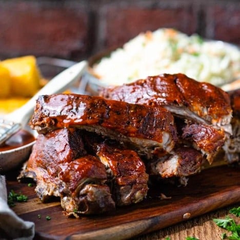 Oven-baked baby back ribs covered in BBQ sauce.