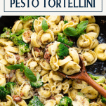 Close overhead shot of pesto tortellini skillet recipe with text title box at top