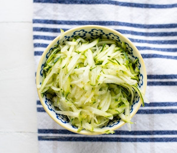 Grated zucchini in a small bowl