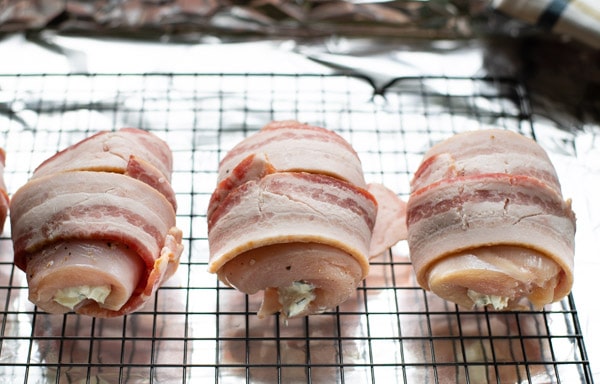 Process shot showing how to cook bacon wrapped chicken