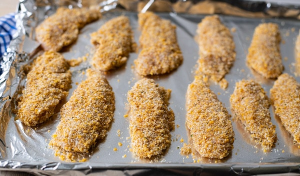 Process shot showing how to make baked chicken tenders