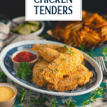 Side shot of a plate of easy baked chicken tenders with text title overlay