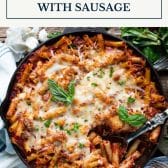 Baked ziti with sausage and text title box at top.