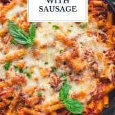 Baked ziti with sausage and text title overlay.