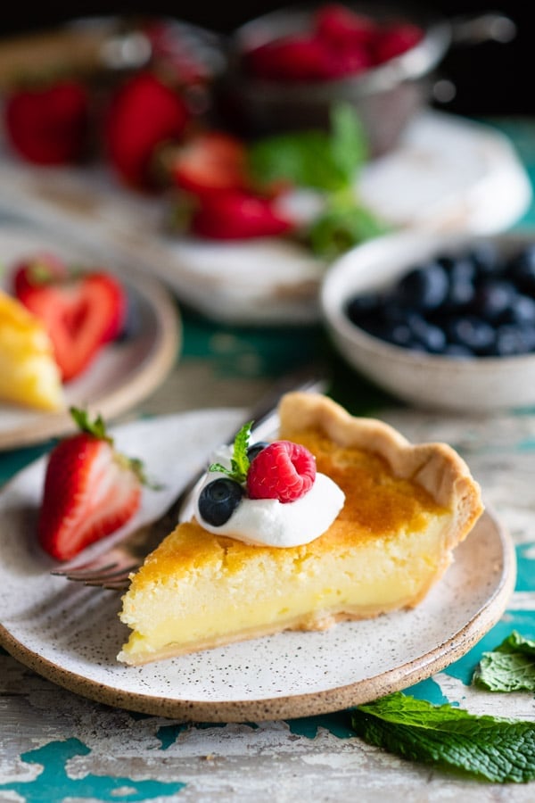 Slice of homemade buttermilk pie with a fork on a plate