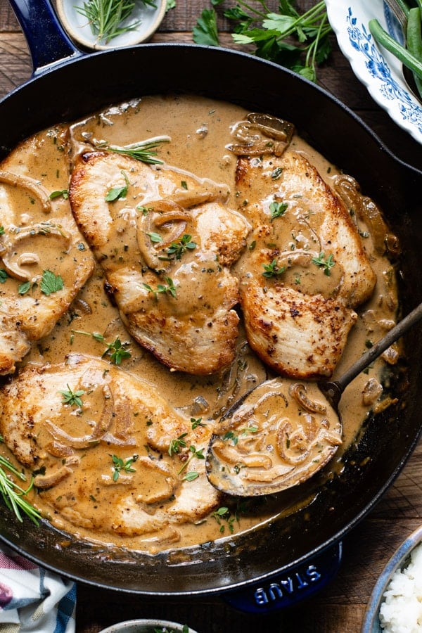 Close overhead image of a pan of chicken Dijon sauce with chicken cutlets