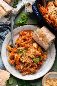 Overhead shot of a plate of baked chicken parmesan casserole with pasta