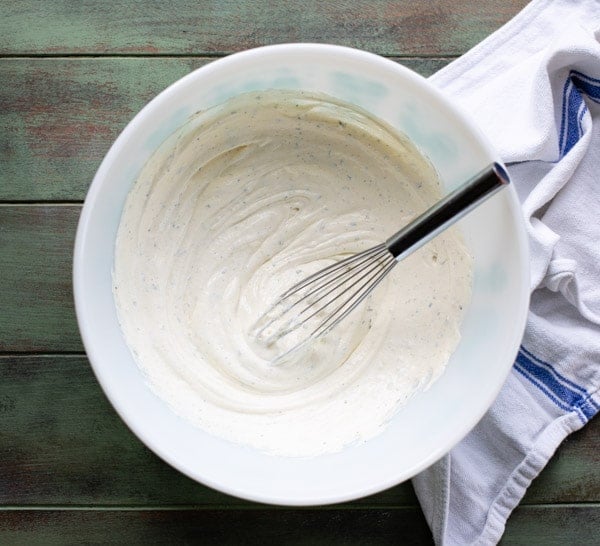 Whisk in a bowl of creamy dressing