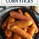 Close overhead image of cast iron corn sticks on a tray with text title overlay