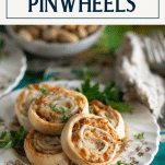Plate of easy baked Italian pinwheel rolls with fresh herbs and text title box at top