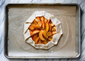 Process shot showing how to make peach galette