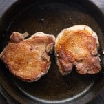 Process shot showing how to make pan fried pork chops
