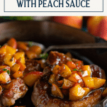 Peach glazed pork chops in a skillet with text title box at top