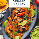 Close overhead image of healthy sheet pan chicken fajitas with text title overlay
