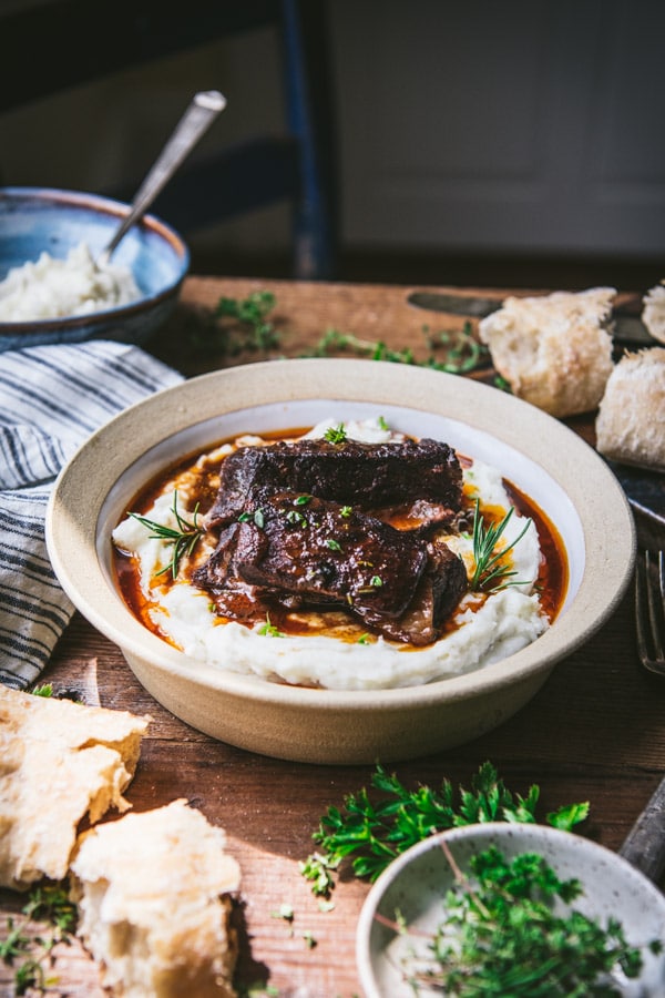Wine-braised short ribs served on a bed of mashed potatoes with a red wine sauce.