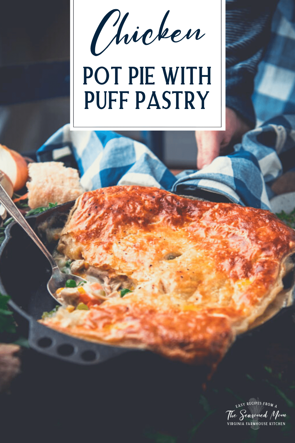 Spoon in a pan of chicken pot pie with puff pastry and text title overlay