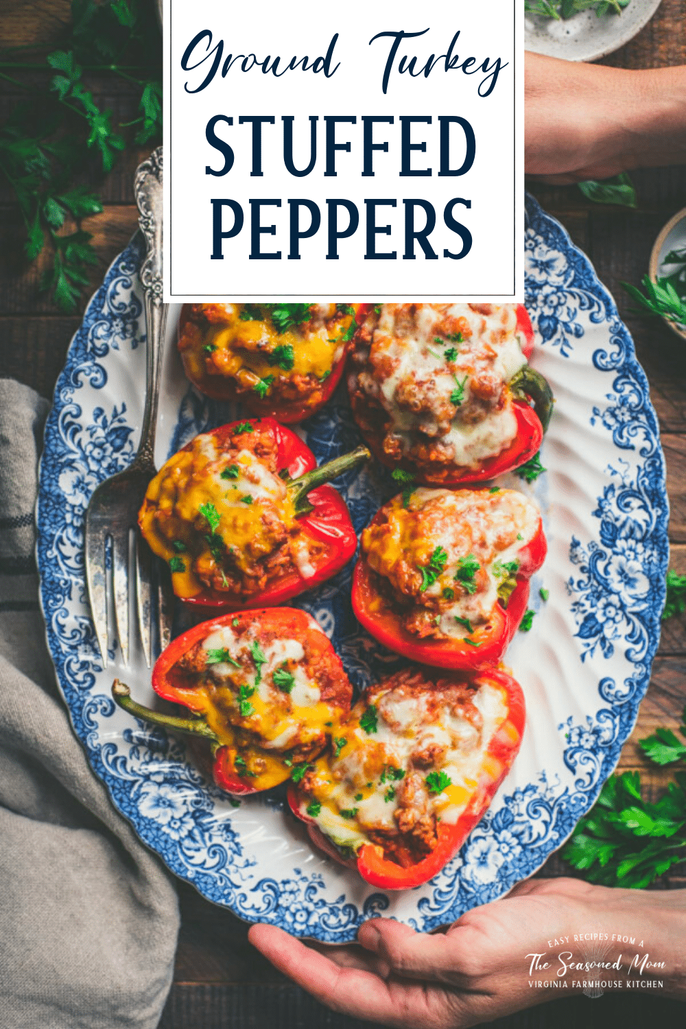 Serving platter full of ground turkey stuffed peppers with text title overlay