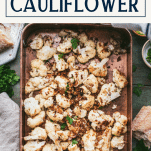Overhead shot of a pan of roasted garlic parmesan cauliflower with text title box at top