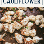 Close shot of garlic parmesan roasted cauliflower with text title box at top