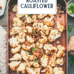 Overhead shot of a pan of roasted cauliflower parmesan bread crumbs with text title overlay