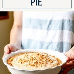 Hands holding a plate of homemade peanut butter pie with text title box at top