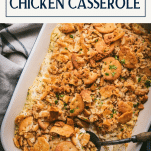 Spoon in a dish of easy poppy seed chicken casserole with text title box at top