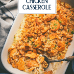 Spoon in a dish of poppy seed chicken casserole with almonds and text title overlay