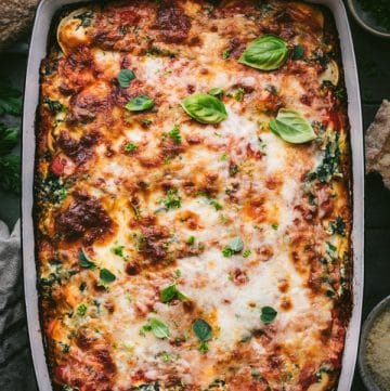 Overhead shot of a pan of baked ravioli with ricotta and spinach