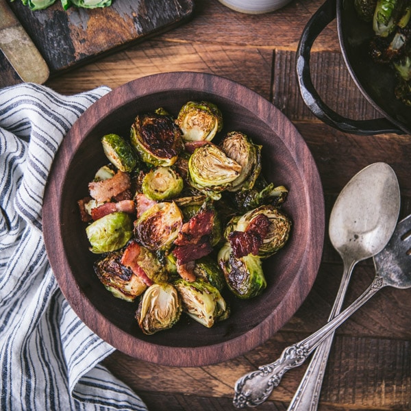 Roasted brussels sprouts in a wooden bowl with bacon and balsamic