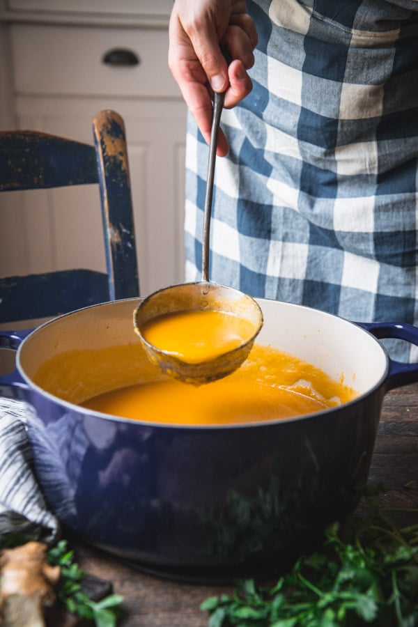 Ladle serving a pot of easy roasted butternut squash soup recipe