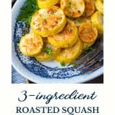 Roasted yellow squash on a blue and white plate with text title at the bottom